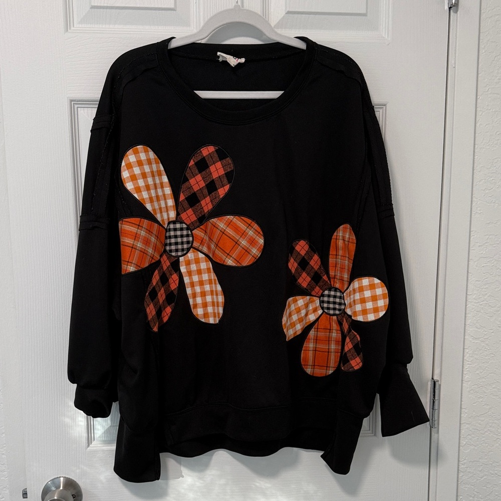 NWOT BiBi Black Sweatshirt with Orange Plaid Flower Design